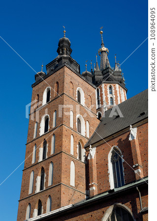 St. Marys Basilica at the Main Square in the Old Town, Krakow, Poland. Detail of domes of Gothic Saint Mary Basilica. Traveling Europe St. Marys Basilica at the Main Square in the Old Town, Krakow, Poland. Detail of domes of Gothic Saint Mary Basilica. Traveling Europe 108964095