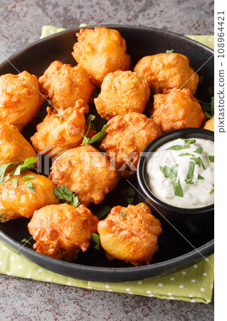 Homemade Deep Fried Hush Puppy Corn Fritters closeup on the plate. Vertical Homemade Deep Fried Hush Puppy Corn Fritters closeup on the plate. Vertical 108964421