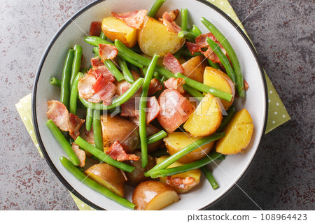 Salade Liegeoise Belgian salad with potatoes, bacon and green beans closeup on the plate. Horizontal top view Salade Liegeoise Belgian salad with potatoes, bacon and green beans closeup on the plate. Horizontal top view 108964423