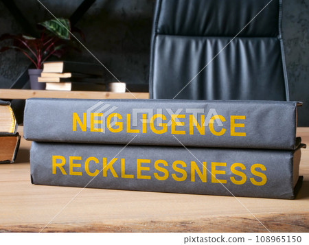Law books about negligence and recklessness on the desk. 108965150