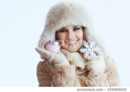 happy stylish woman in winter coat and fur hat on white 108966692