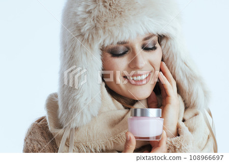 smiling woman in winter coat and fur hat on white smiling woman in winter coat and fur hat on white 108966697