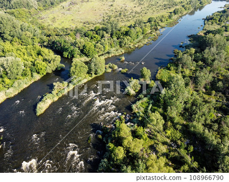 Picturesque river rapids on the Southern Bug. Rapid flow of the river over rocky terrain, landscape from a bird's eye view. Picturesque river rapids on the Southern Bug. Rapid flow of the river over rocky terrain, landscape from a bird's eye view. 108966790