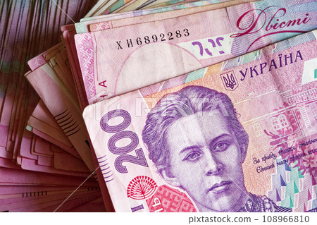 A stack of Ukrainian 200 hryvnia banknotes, with a portrait visible on the notes. A bunch of banknotes with a face value of two hundred hryvnias. Ukrainian money. A stack of Ukrainian 200 hryvnia banknotes, with a portrait visible on the notes. A bunch of banknotes with a face value of two hundred hryvnias. Ukrainian money. 108966810