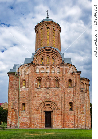 The Pyatnitskaya Church, a medieval brick church in the Ukrainian city of Chernihiv, emerges as a striking red brick structure with a dome and a cross atop, set against the expansive clear sky. The Pyatnitskaya Church, a medieval brick church in the Ukrainian city of Chernihiv, emerges as a striking red brick structure with a dome and a cross atop, set against the expansive clear sky. 108966814