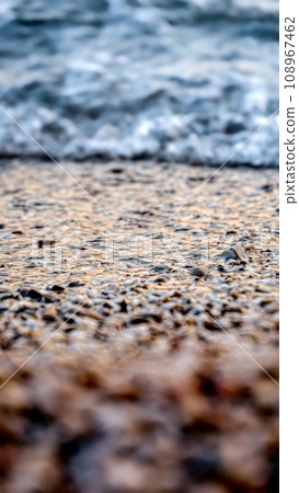 Calm sea waves rolling and braking on rocky ocean beach at sunset. Holiday, summer vacation and tourism 108967462