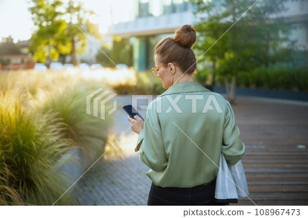 Seen from behind woman worker near business center 108967473