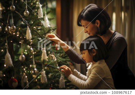 Chinese mom and daughter decorate a Christmas tree together Chinese mom and daughter decorate a Christmas tree together 108967617