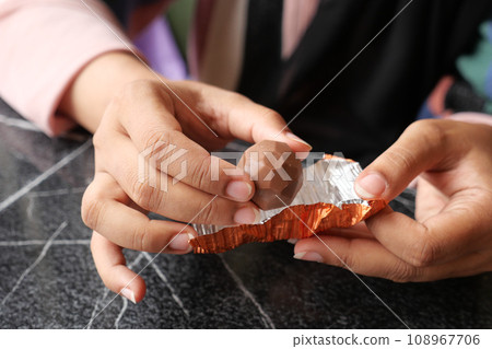 removing packet from a chocolate removing packet from a chocolate 108967706
