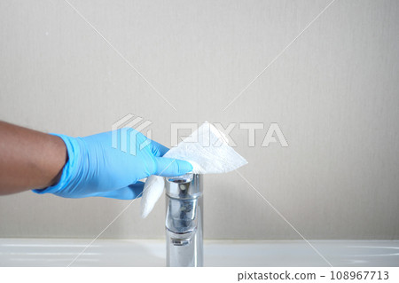 hand in gloves cleaning tap and washbasin, 108967713