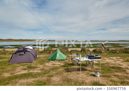 Tents for camping on the shore of a sea bay Tents for camping on the shore of a sea bay 108967756