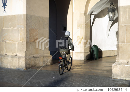 A man on eco transport goes to work. Full-length shot of man riding a rented bike. 108968544