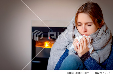 AI-generated image of a woman with a cold and wearing a muffler AI-generated image of a woman with a cold and wearing a muffler 108968708