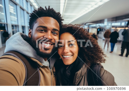 Waiting for the flight. Happy black couple having fun together in the terminal before boarding their flight. Waiting for the flight. Happy black couple having fun together in the terminal before boarding their flight. 108970896