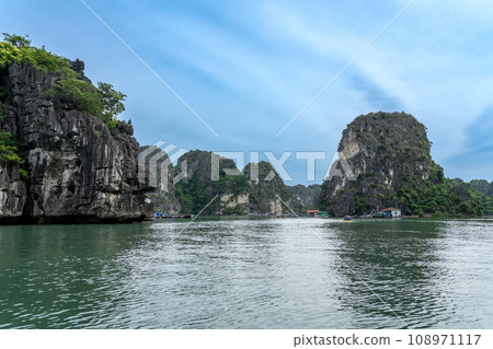 Vietnam: A village of people who live on the water in Ha Long Bay, surrounded by strangely shaped rocks. Vietnam: A village of people who live on the water in Ha Long Bay, surrounded by strangely shaped rocks. 108971117
