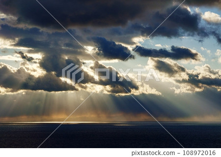 Dynamic evening sky and sea with rays of light, winter, 220114pm 108972016