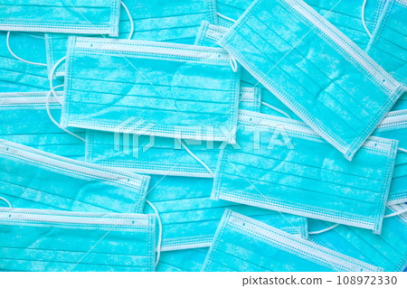 Blue surgical face mask texture background protection against air pollution and COVID-19 coronavirus. Healthcare and medical concept Blue surgical face mask texture background protection against air pollution and COVID-19 coronavirus. Healthcare and medical concept 108972330