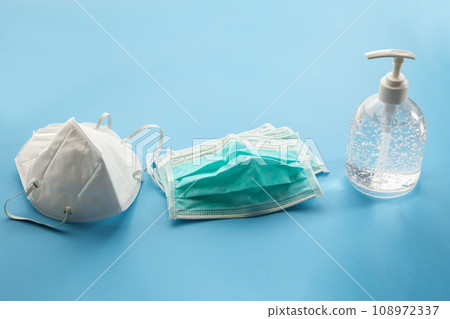 Alcohol sanitizer gel hand wash bottle with N95 Medical face mask on blue background covid-19 Coronavirus prevention concept 108972337