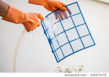 Asian man cleaning air conditioner dirty filter Asian man cleaning air conditioner dirty filter 108972478