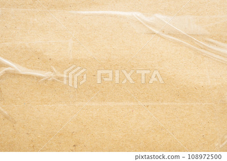 transparent adhesive tape on old brown cardboard paper background transparent adhesive tape on old brown cardboard paper background 108972500