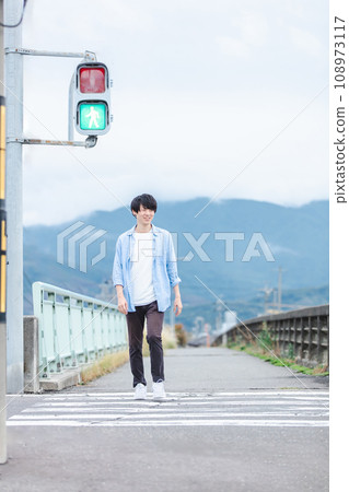 man crossing the crosswalk 108973117