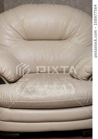 Defects on a white leather sofa. Damaged to leather furniture. Close up of damaged white leather soft tufted furniture. Bad quality leather 108977564