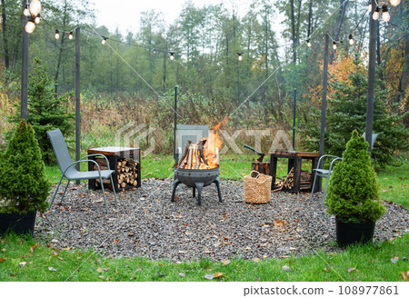 Fire pit and burning fire in a garden 108977861