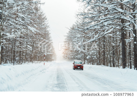 Beautiful snow road forest view during car driving in winter season. Winter travel, Road trip, Adventure, Exploring and Vacation concepts 108977963