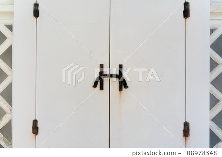 White warehouse door and rusty bolts White warehouse door and rusty bolts 108978348