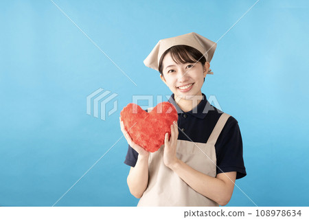 House cleaning female worker with red heart on blue background 108978634