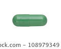 A pill, a tablet of green color isolated on a white background. Close-up. Top view. 108979349