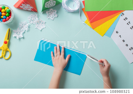 Advent calendar made of colored paper. Diy for children. flat lay. step 2 Advent calendar made of colored paper. Diy for children. flat lay. step 2 108980321