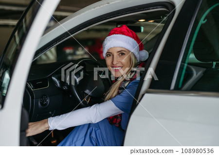 Beautiful nurse with christmas hat finishing a shift at hospital and going home. Working in hospital on Christmas day, Christmas Eve. Female doctor arriving at Christmas shift and can't be with her Beautiful nurse with christmas hat finishing a shift at hospital and going home. Working in hospital on Christmas day, Christmas Eve. Female doctor arriving at Christmas shift and can't be with her 108980536