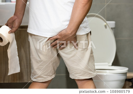 Middle aged man hold toilet paper,touching his butt worried about defecation fearing pain from hemorrhoids,Stressed male has acute diarrhea and suffers from hemorrhoids,health problem,health care Middle aged man hold toilet paper,touching his butt worried about defecation fearing pain from hemorrhoids,Stressed male has acute diarrhea and suffers from hemorrhoids,health problem,health care 108980579