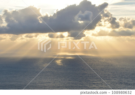 Sunset over the sea in a cloudy sky 108980632