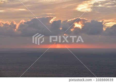 Sunset over the sea in a cloudy sky Sunset over the sea in a cloudy sky 108980639