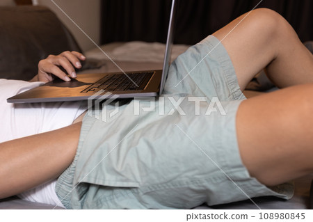 Man searching for pornography videos,hand of male in pants,stimulate one's own genitals for sexual pleasure,masturbation while watching porn online or looking pornographic images on laptop computer 108980845