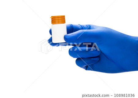 Hand with medical glove holding pill bottle 108981036