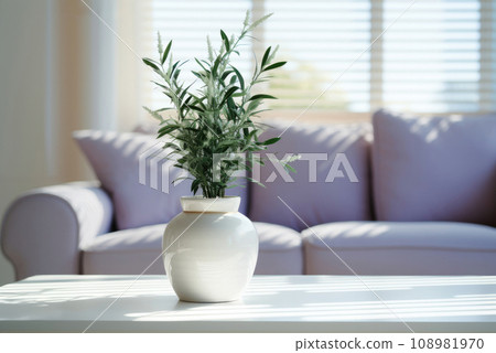 Lavender in a white ceramic pot in a cozy living room in a lilac sofa with copy space 108981970