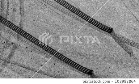 Aerial top view auto tire tread element, Car tire pattern, Wheel tyre tread track, Black tyre print on asphalt road. Aerial top view auto tire tread element, Car tire pattern, Wheel tyre tread track, Black tyre print on asphalt road. 108982864