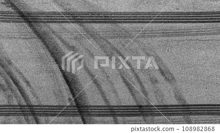 Aerial top view auto tire tread element, Car tire pattern, Wheel tyre tread track, Black tyre print on asphalt road. 108982868