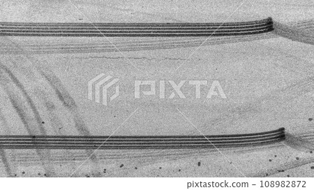Aerial top view auto tire tread element, Car tire pattern, Wheel tyre tread track, Black tyre print on asphalt road. 108982872