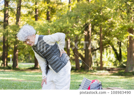 Senior woman with low back pain 108983490