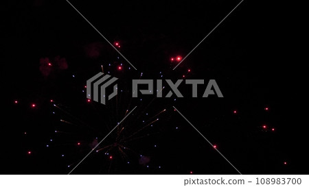 Shining firework explosion with bright colors in night sky at holiday party Shining firework explosion with bright colors in night sky at holiday party 108983700