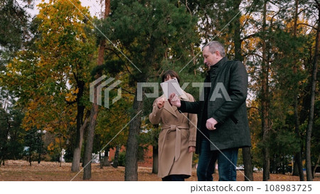 Woman explains principles of company during meeting with investor in park Woman explains principles of company during meeting with investor in park 108983725