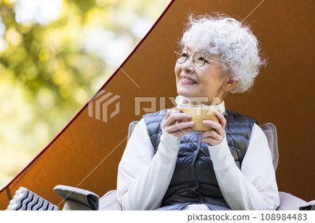 A woman in her 60s enjoying camping A woman in her 60s enjoying camping 108984483