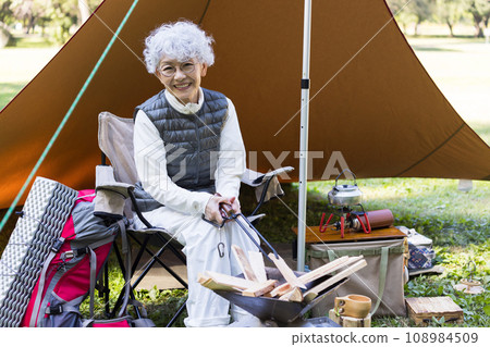 A woman in her 60s enjoying camping A woman in her 60s enjoying camping 108984509