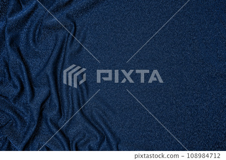 Background of draped dark blue fabric with silver lurex thread Background of draped dark blue fabric with silver lurex thread 108984712