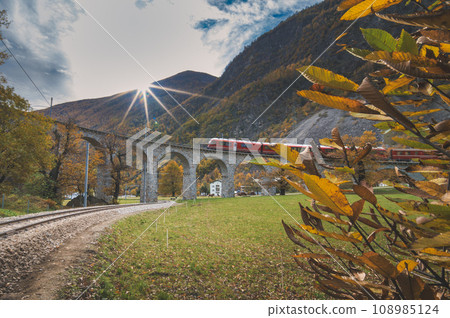 The red tourist train of the Swiss Alps in Brusio The red tourist train of the Swiss Alps in Brusio 108985124