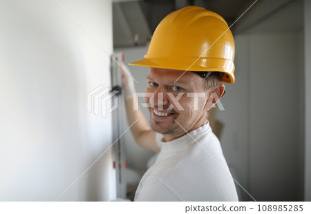 Smiling worker wearing helmet Smiling worker wearing helmet 108985285